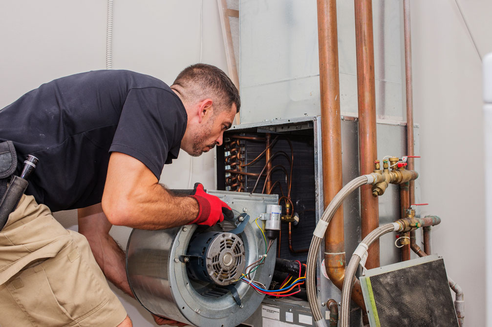 Heating Installation Technician installing furnace unit