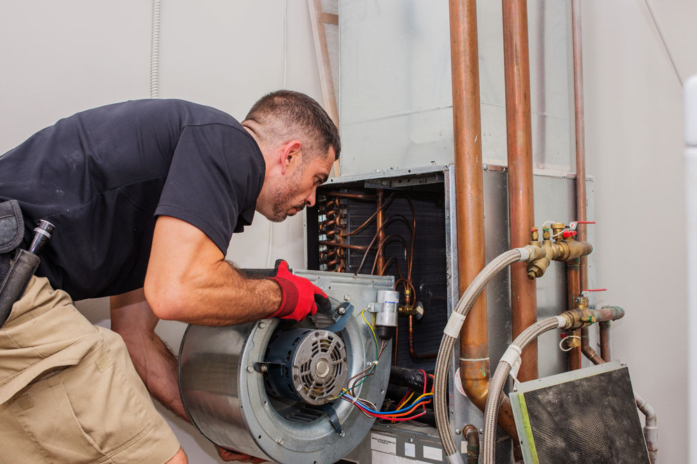 Technician installing furnace unit